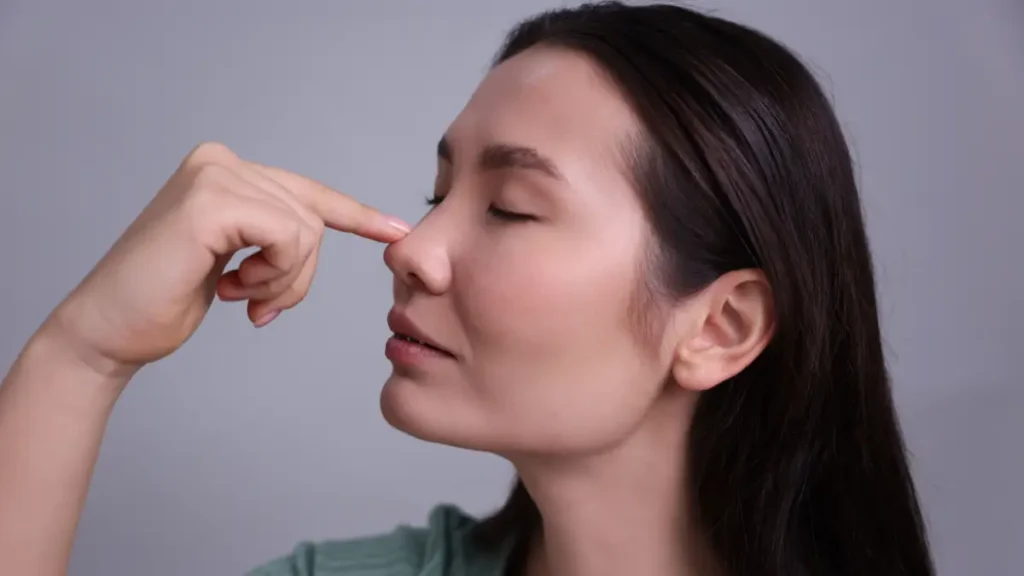 A teenager touches her nose as part of a quick focus brain break.