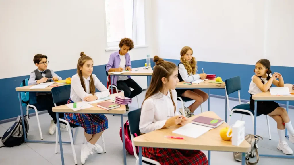 Six students sit at their desks enjoying a quiet reward. The class is neat and not noisy.