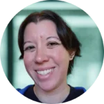A headshot of Tori, classroom management coach and former classroom teacher, in front of a blurry green background. Tori has short dark hair and a sincere smile. Her eyes are bright and eager to help teachers get control of their classrooms.