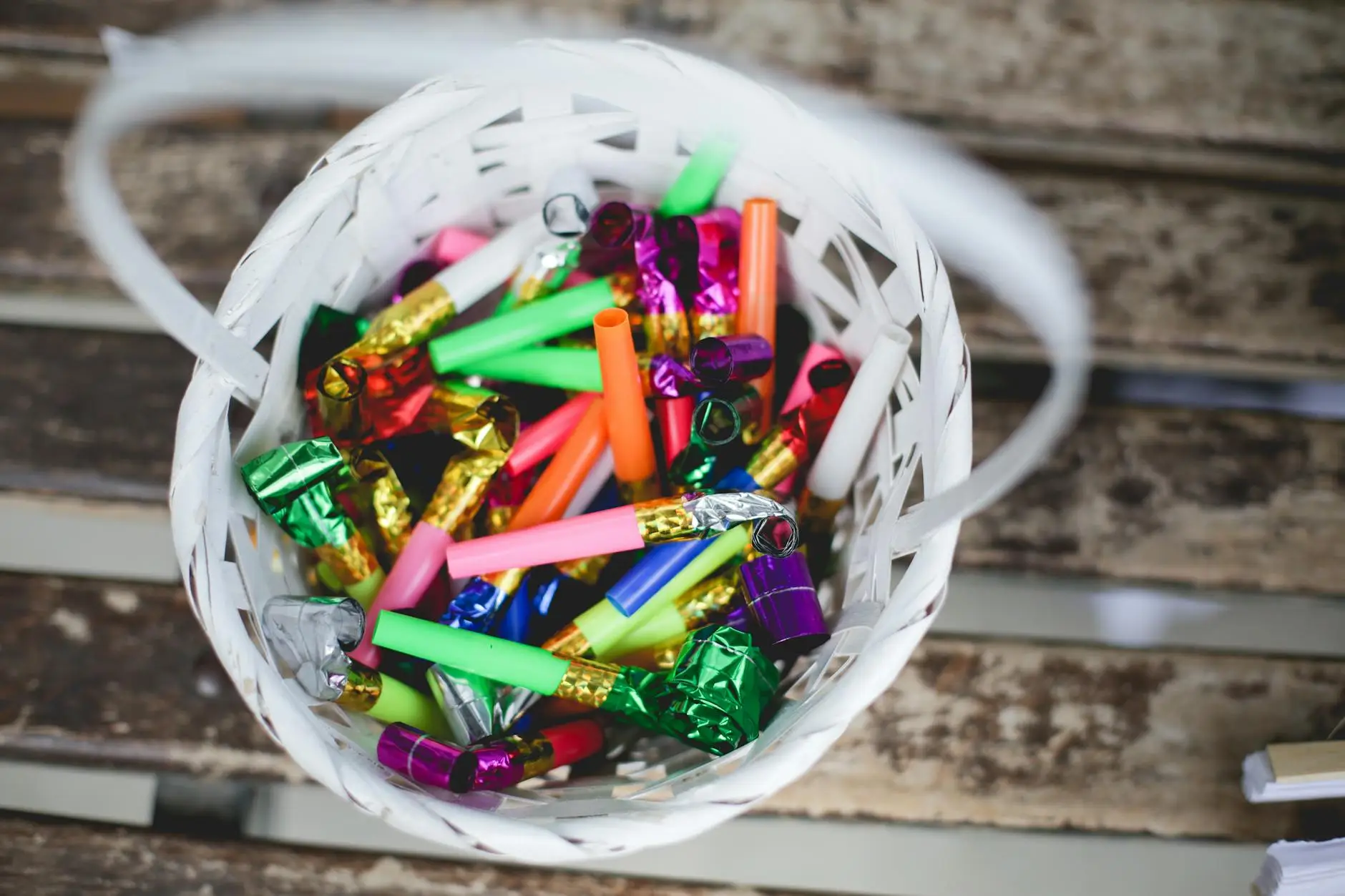 A basket of colorful noisemakers sits on wooden slats, representing an auditory quiet signal for students