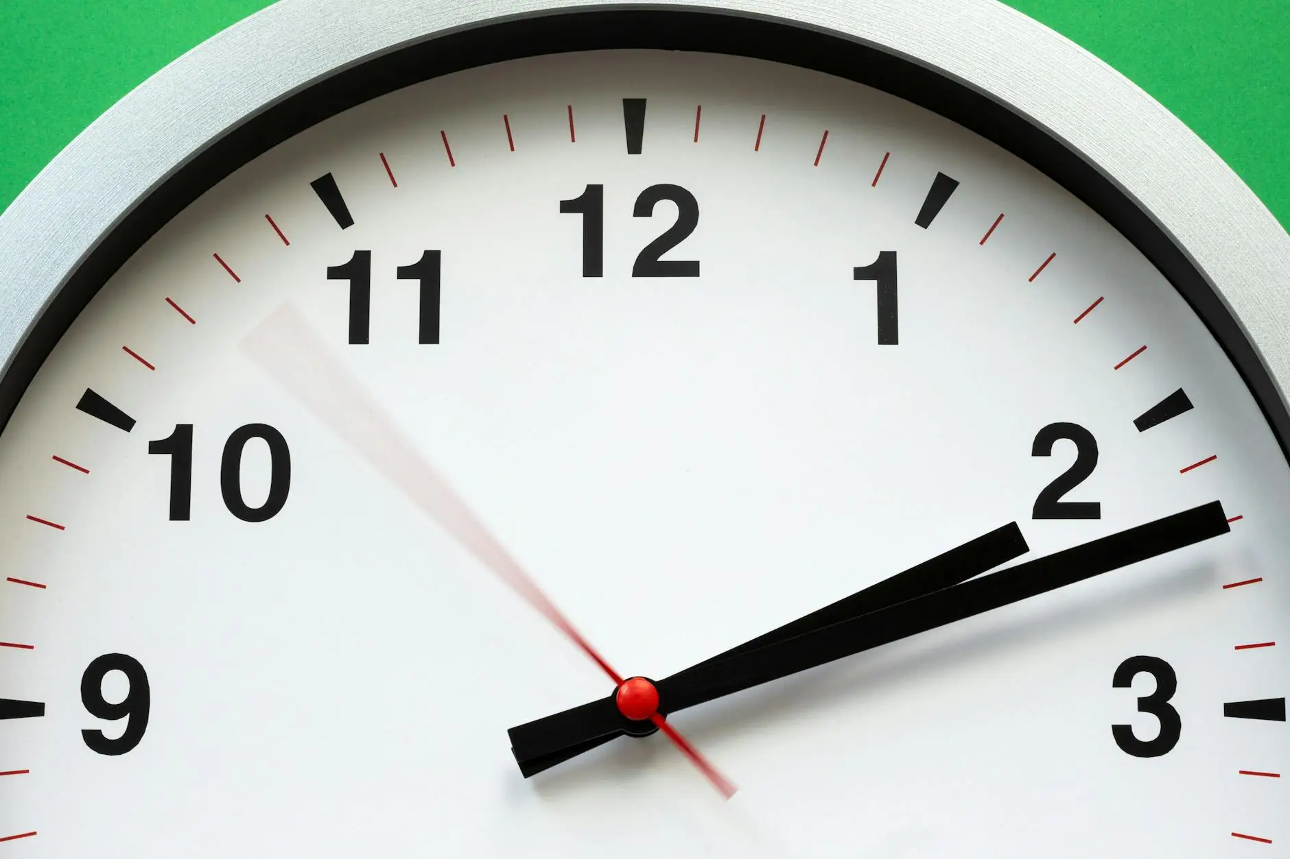 The top half of a wall clock with a blurred second hand, showing the rapid progression of time during a parent-teacher conference
