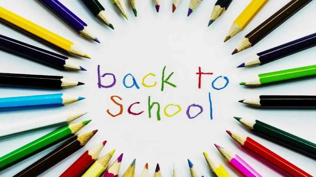 Sharpened colored pencils in a circle all pointing to the words BACK TO SCHOOL representing a back-to-school bulletin board in a classroom