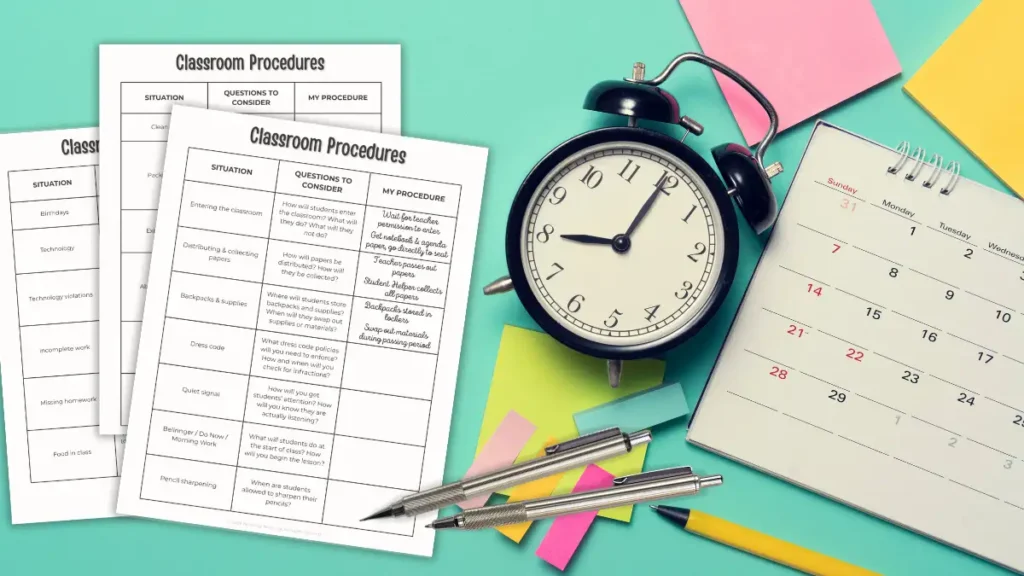 A trio of pages partially filled out labeled Classroom Procedures rest on a teal desk beside sticky flags, pens, a calendar, and an old-fashioned alarm clock