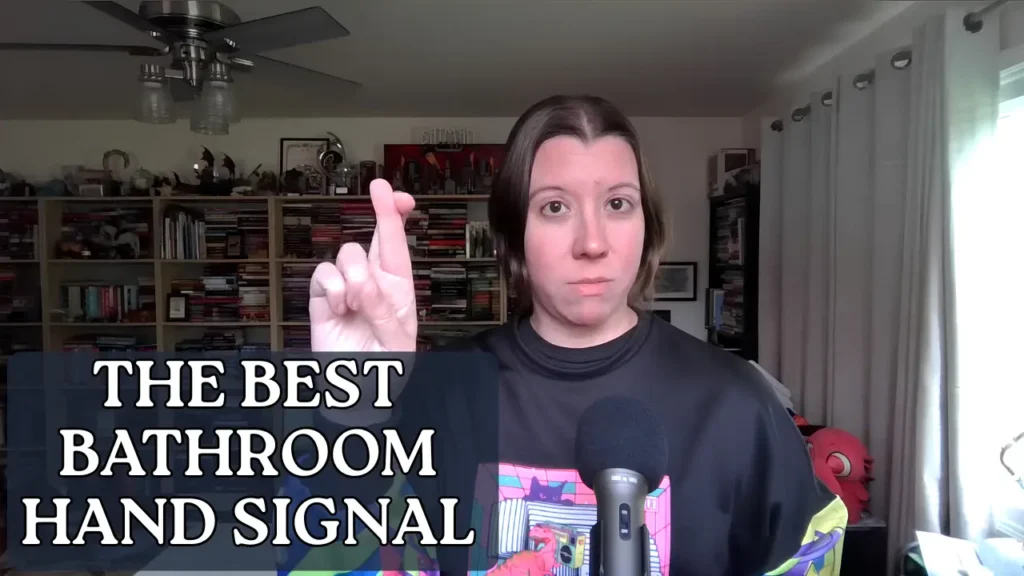 A screenshot from a YouTube video demonstrating the best silent bathroom hand signal for upper elementary and middle school classrooms