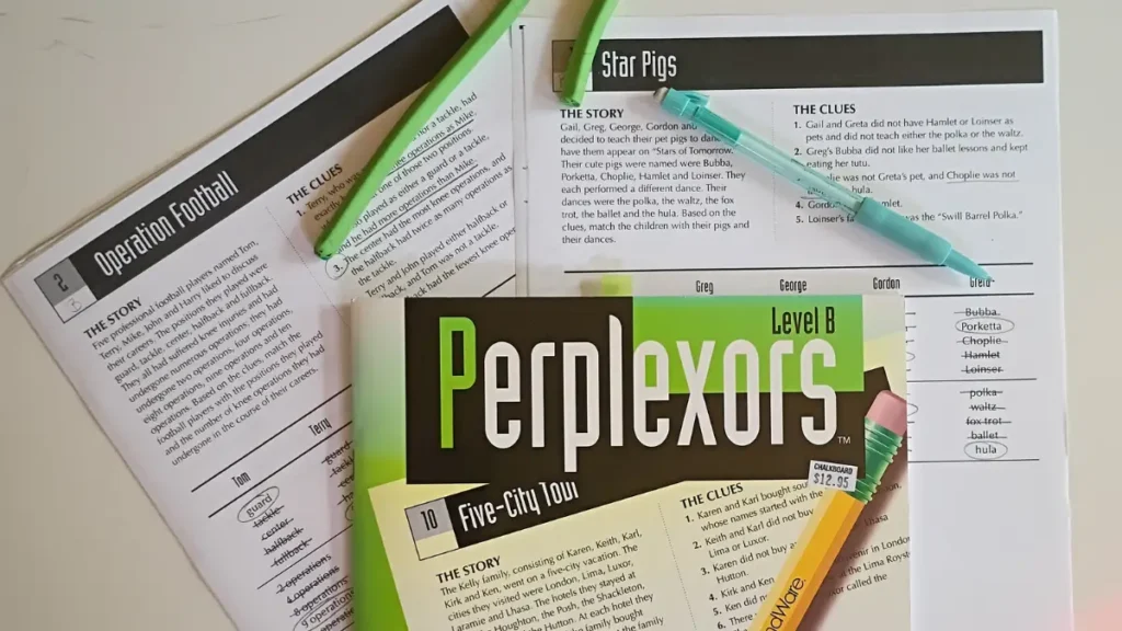 The cover of a book of Perplexors along with some printed partially-completed perplexors, a long skinny eraser rope and a mechanical pencil