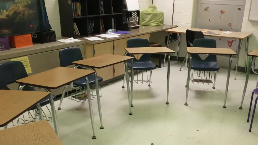 A photo of a classroom with the desks arranged in a circle